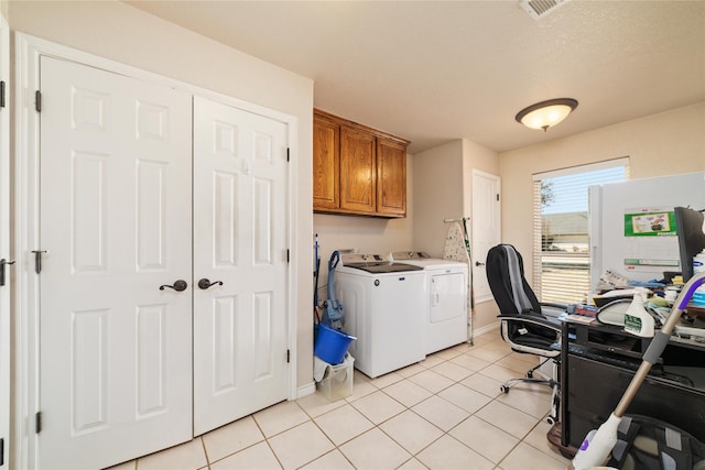 washroom with visible vents, baseboards, cabinet space, light tile patterned flooring, and independent washer and dryer