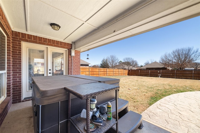 view of patio / terrace with a hot tub and a fenced backyard