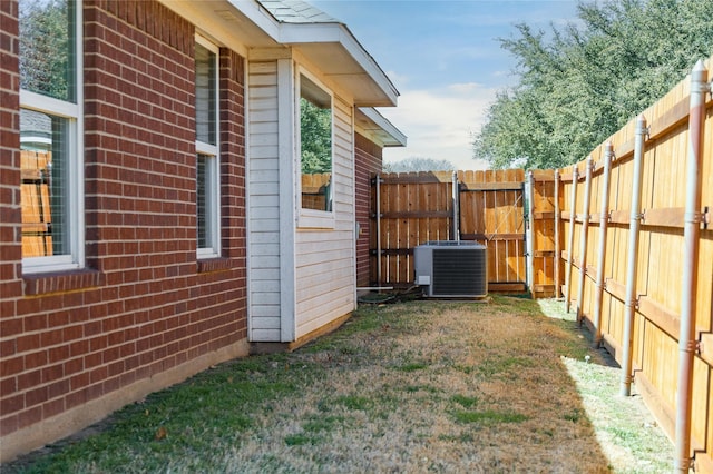 view of yard with central air condition unit and a fenced backyard