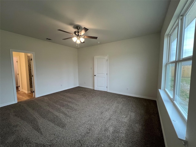 unfurnished room featuring visible vents, ceiling fan, baseboards, and carpet floors