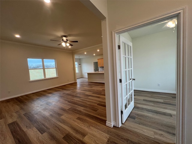 interior space with crown molding and dark wood-type flooring