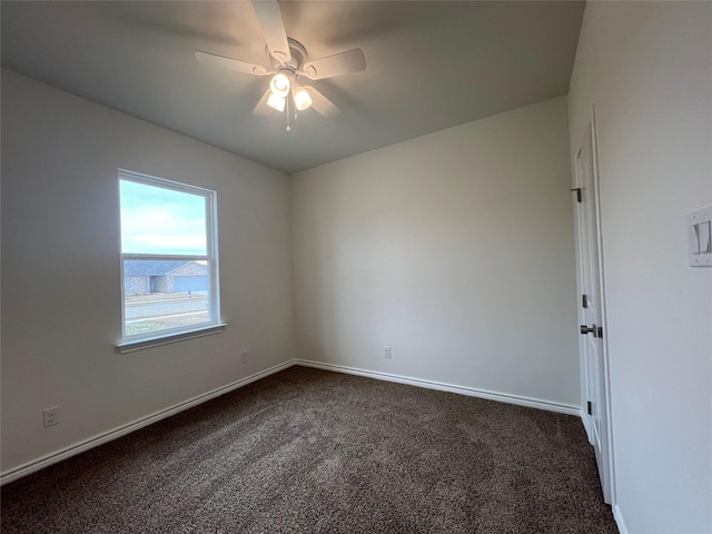 unfurnished room featuring dark colored carpet, baseboards, and a ceiling fan