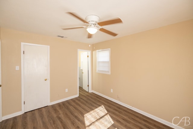 unfurnished bedroom with visible vents, ceiling fan, baseboards, and wood finished floors