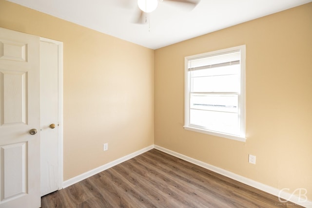 unfurnished room featuring a ceiling fan, baseboards, and wood finished floors