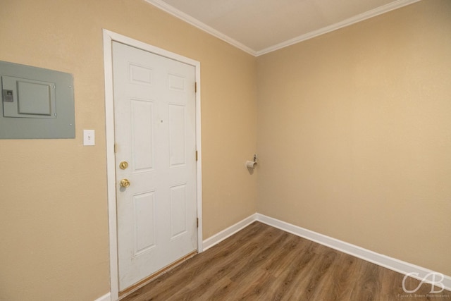 entryway featuring electric panel, baseboards, dark wood-type flooring, and ornamental molding