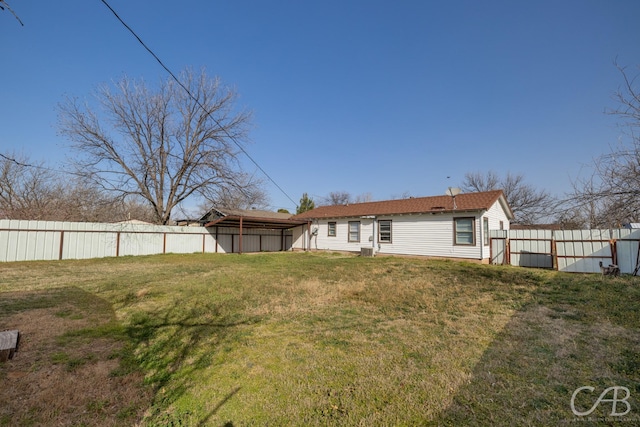 back of property featuring a yard and fence