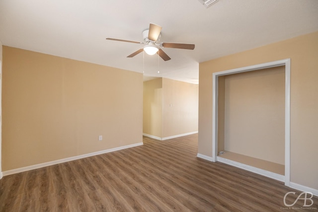 unfurnished room featuring a ceiling fan, baseboards, and wood finished floors