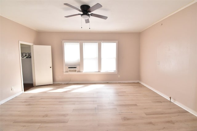 unfurnished bedroom featuring cooling unit, a ceiling fan, baseboards, light wood finished floors, and ornamental molding