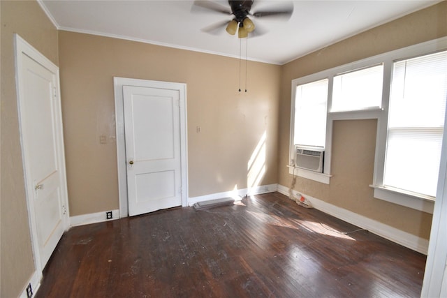 empty room featuring cooling unit, baseboards, dark wood finished floors, and crown molding