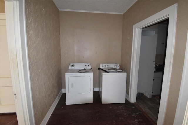 laundry room with wood finished floors, separate washer and dryer, crown molding, baseboards, and laundry area