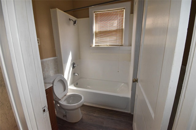 full bath with toilet, vanity, bathtub / shower combination, and wood finished floors