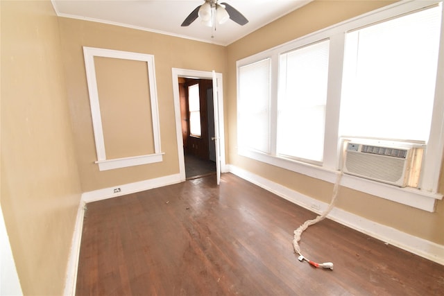 spare room with cooling unit, baseboards, wood finished floors, and crown molding