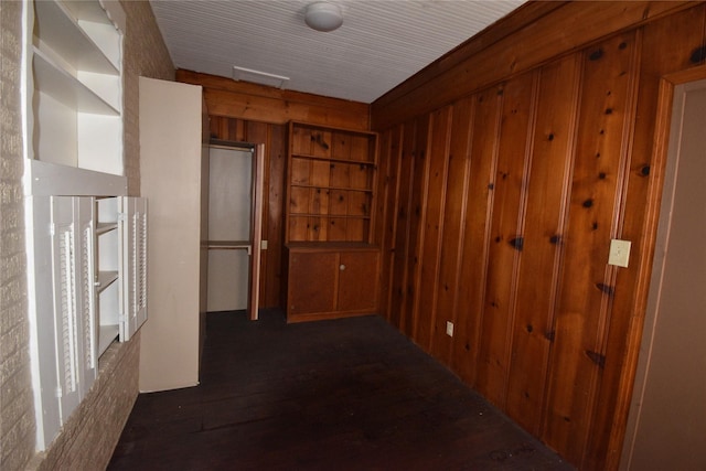 corridor featuring wood walls and wood finished floors