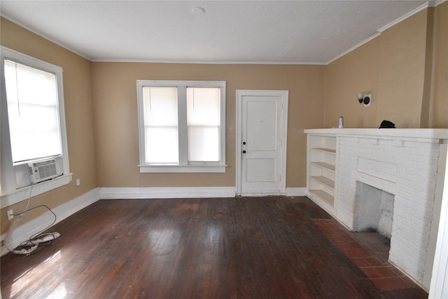 unfurnished living room with cooling unit, wood finished floors, baseboards, and a wealth of natural light