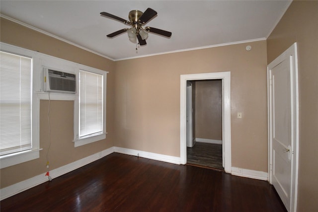 spare room featuring crown molding, wood finished floors, baseboards, and a wall mounted air conditioner