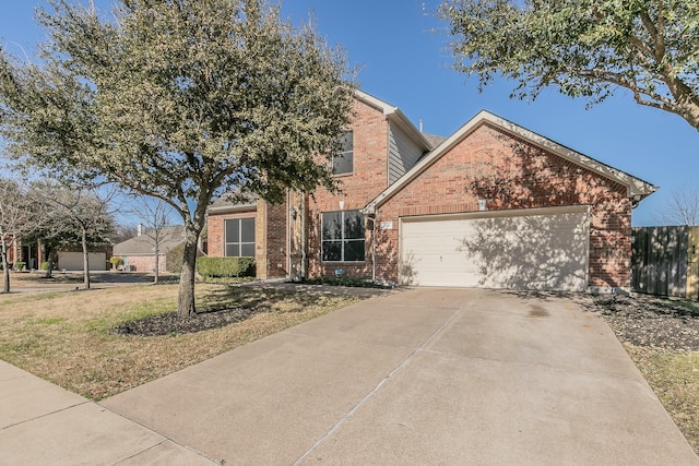 traditional-style house featuring brick siding, an attached garage, concrete driveway, and a front yard
