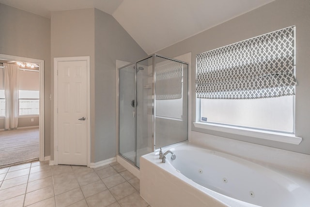 bathroom featuring a stall shower, a jetted tub, tile patterned flooring, lofted ceiling, and baseboards