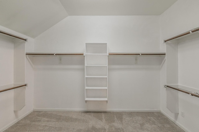 spacious closet with carpet floors and lofted ceiling