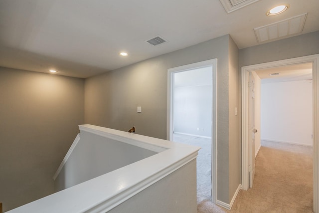 corridor with light colored carpet, an upstairs landing, recessed lighting, and baseboards