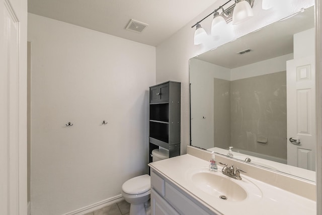 bathroom with toilet, vanity, tile patterned floors, and baseboards
