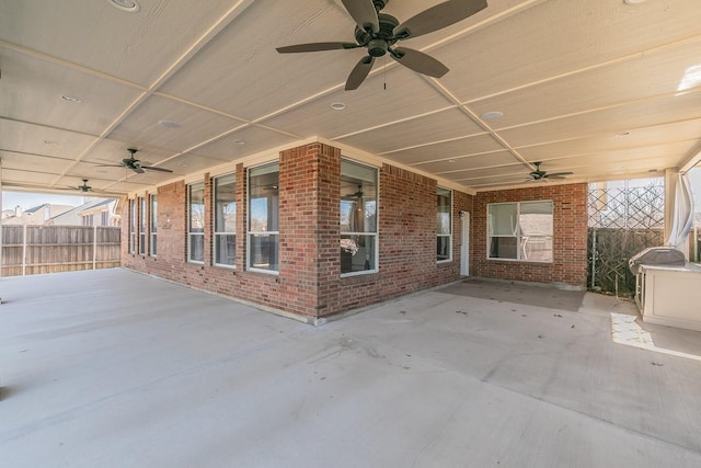 view of patio featuring ceiling fan and fence