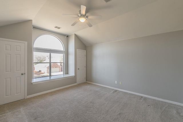 additional living space featuring vaulted ceiling, a ceiling fan, carpet flooring, and baseboards