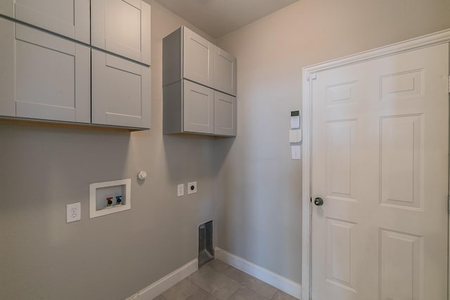 laundry area featuring cabinet space, baseboards, hookup for an electric dryer, hookup for a gas dryer, and hookup for a washing machine