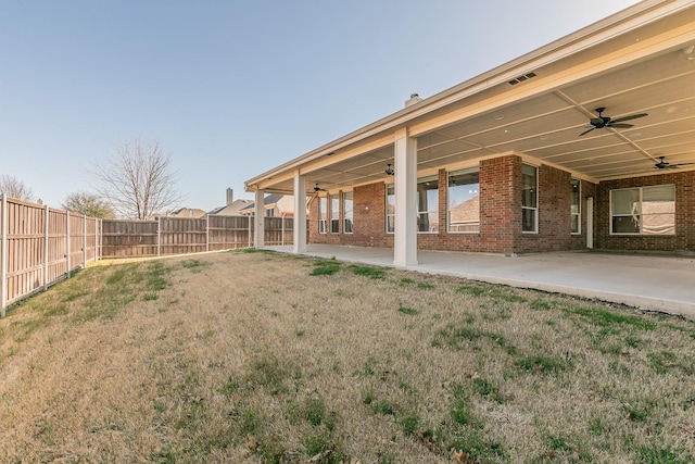 view of yard featuring a patio, a fenced backyard, and ceiling fan