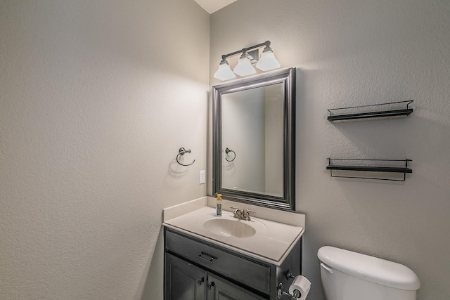half bathroom featuring toilet and vanity