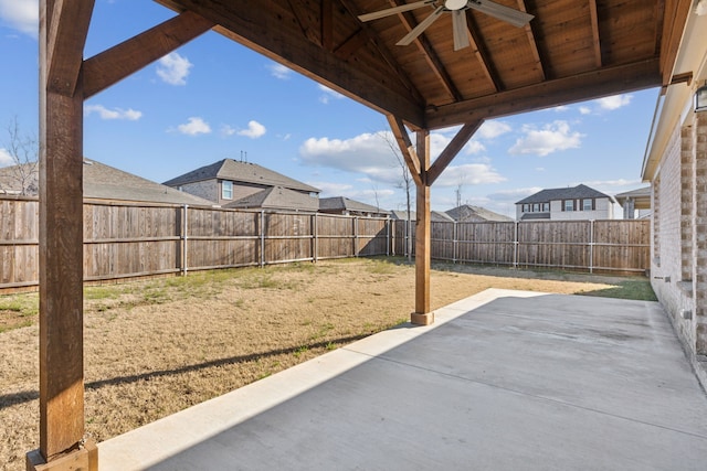 view of patio with a fenced backyard, a residential view, and ceiling fan