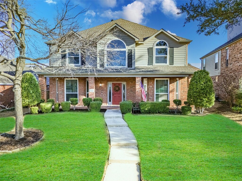 2413 Cimmaron Dr, Plano, TX 75025 - traditional home with brick siding, a shingled roof, and a front lawn