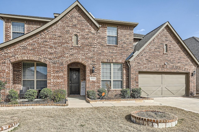 view of front of property featuring brick siding, concrete driveway, and a garage