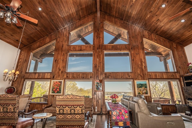 unfurnished living room with wooden ceiling, wooden walls, and high vaulted ceiling