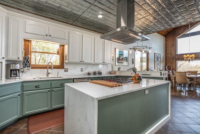 kitchen with a notable chandelier, an ornate ceiling, island exhaust hood, and green cabinets