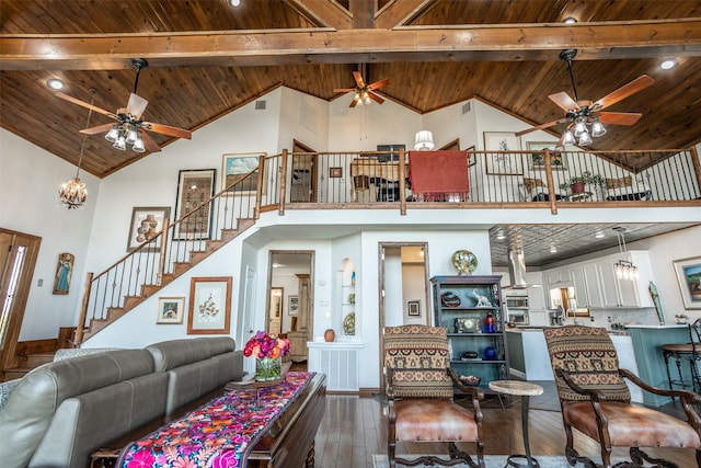 living area with dark wood finished floors, stairs, ceiling fan with notable chandelier, wooden ceiling, and high vaulted ceiling