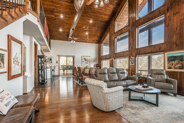 living area featuring a wealth of natural light, wood-type flooring, high vaulted ceiling, and wooden ceiling