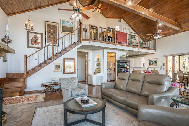 living room featuring beam ceiling, high vaulted ceiling, hardwood / wood-style floors, wooden ceiling, and stairs