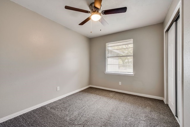 unfurnished bedroom with a closet, carpet floors, baseboards, and ceiling fan