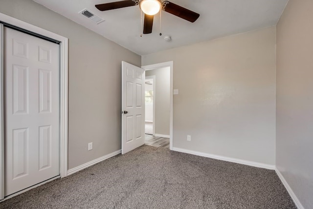 unfurnished bedroom featuring carpet, visible vents, and baseboards