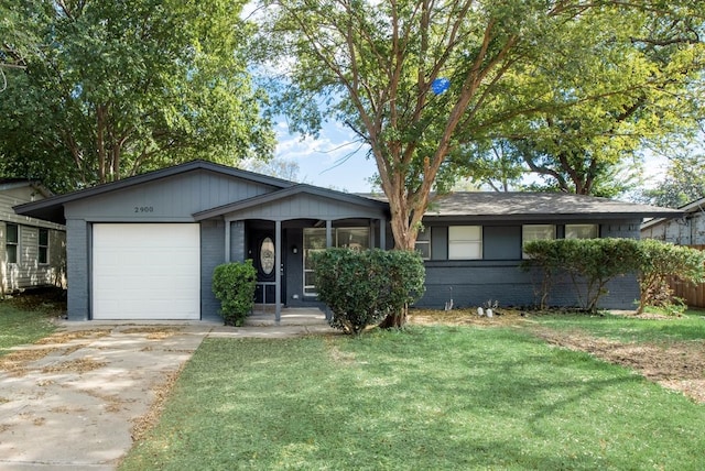 single story home featuring a front yard, an attached garage, brick siding, and concrete driveway