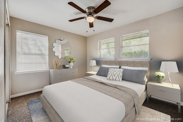 carpeted bedroom with a ceiling fan and baseboards