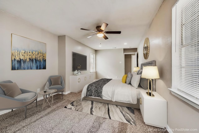 carpeted bedroom with a ceiling fan and baseboards