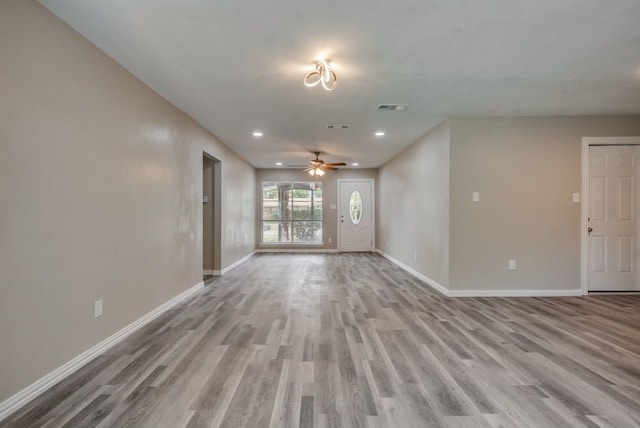 unfurnished living room with light wood finished floors, visible vents, baseboards, recessed lighting, and a ceiling fan