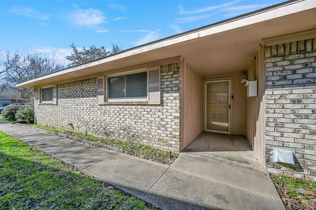 entrance to property with brick siding