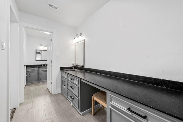 bathroom with tile patterned flooring, visible vents, and vanity