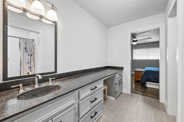 bathroom featuring baseboards, vanity, and a ceiling fan