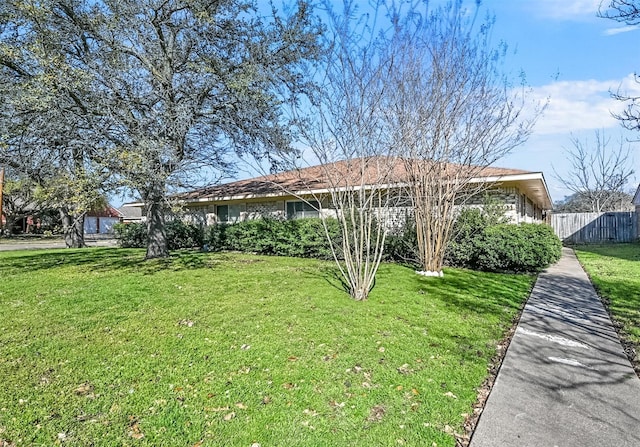 exterior space with a front lawn and fence