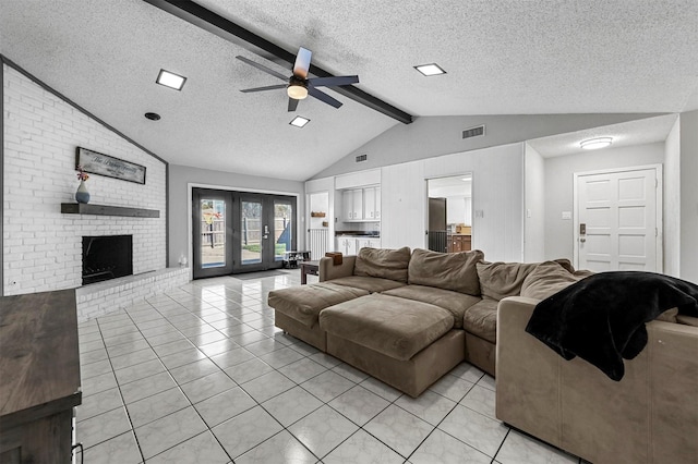 living room featuring lofted ceiling with beams, visible vents, a brick fireplace, and light tile patterned floors