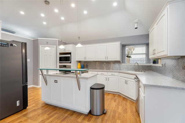 kitchen featuring a sink, white cabinets, a kitchen island, and stainless steel appliances