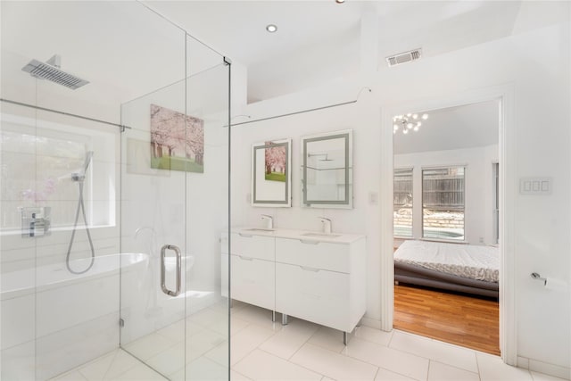 ensuite bathroom featuring visible vents, connected bathroom, a shower stall, and tile patterned flooring